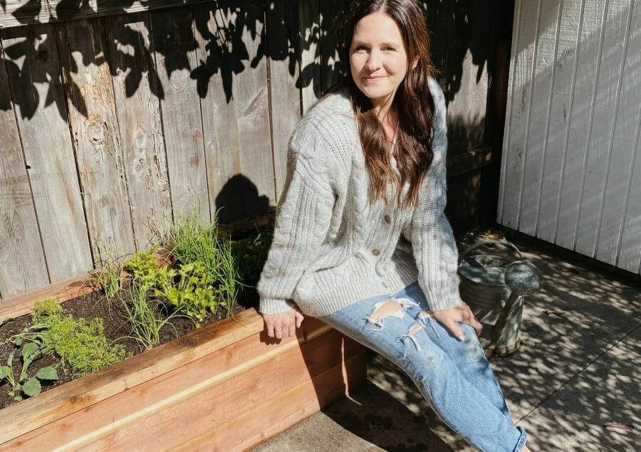 woman sitting on a raised garden bed