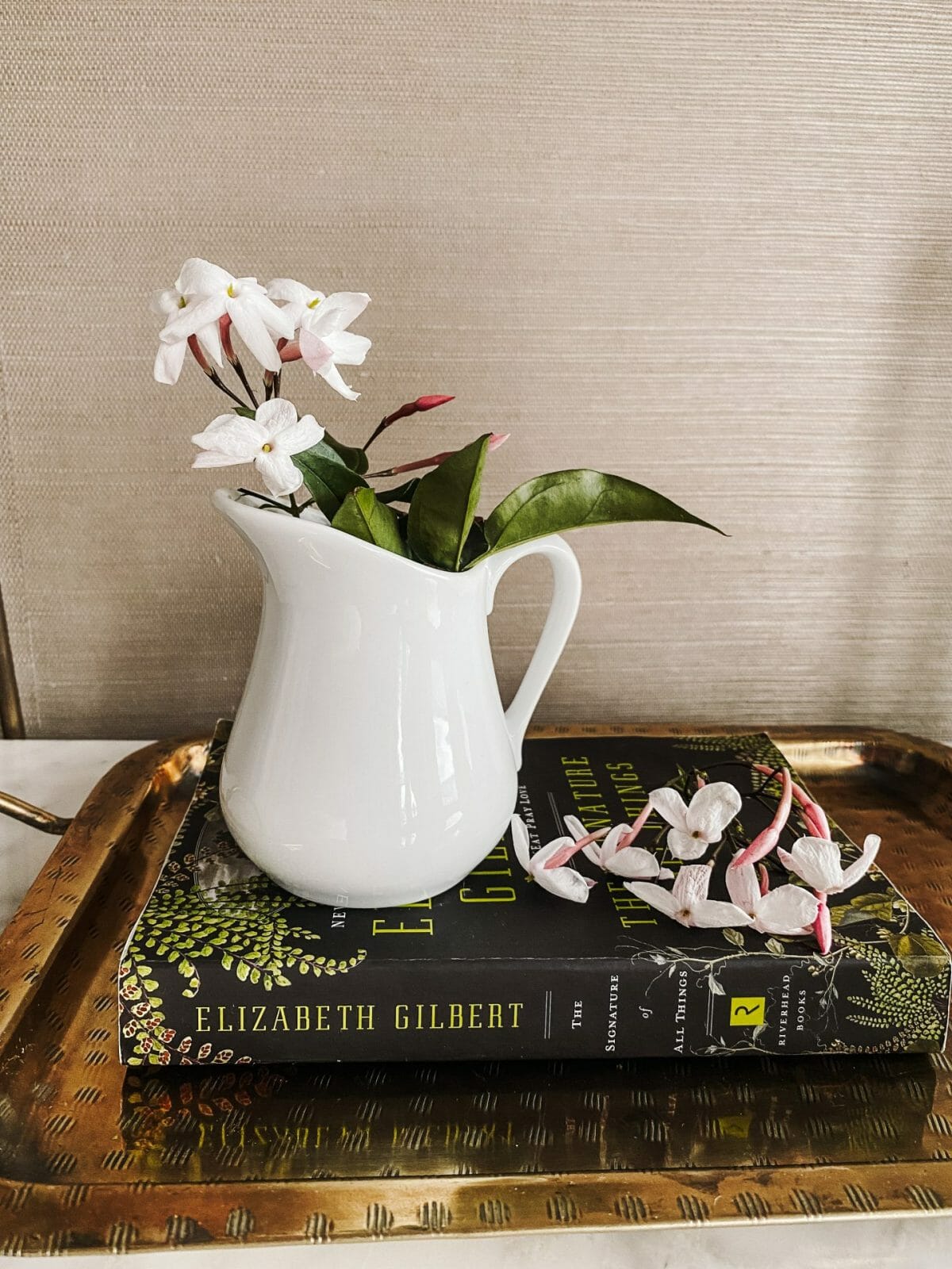 jasmine in a vase on a book